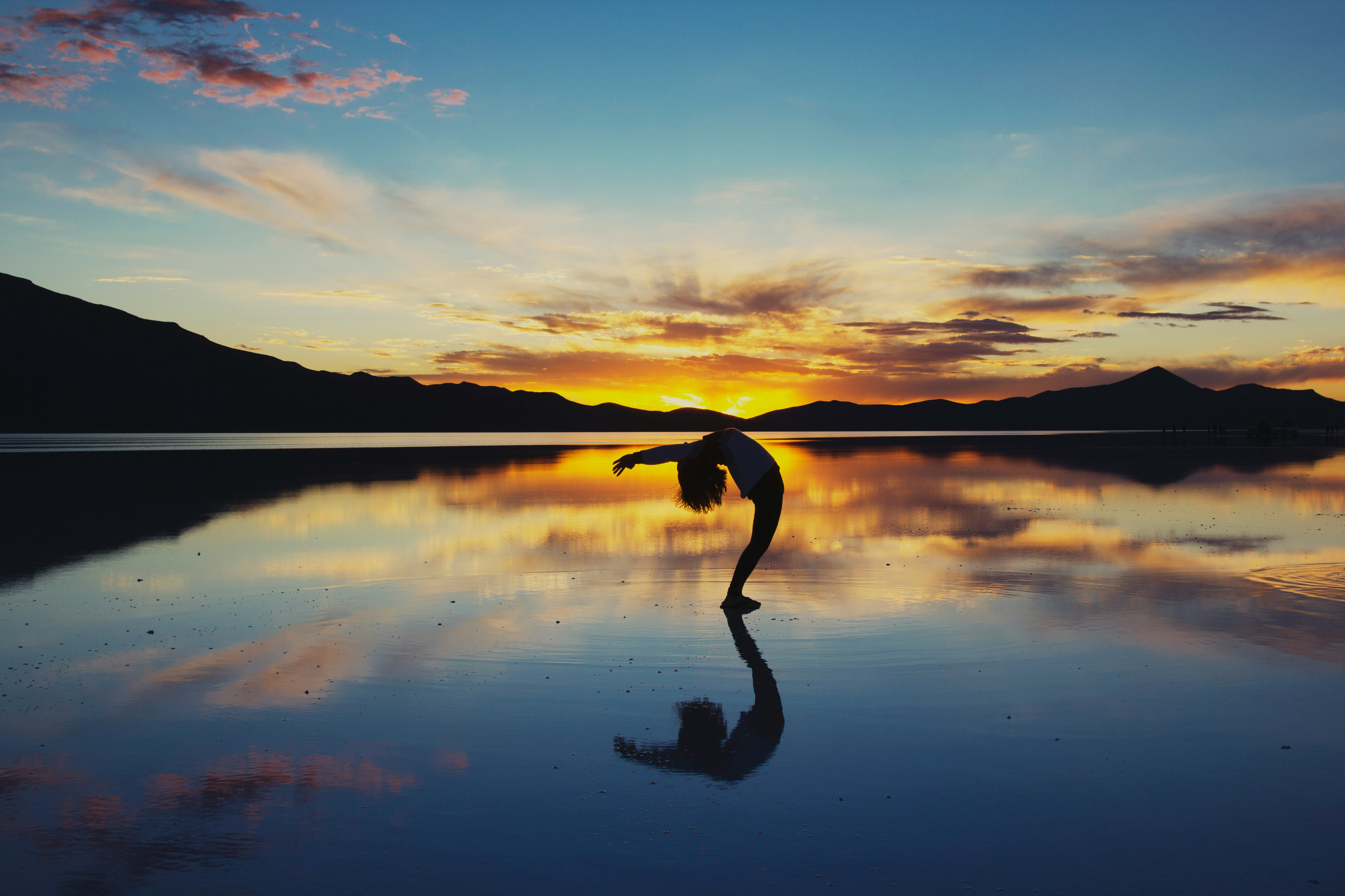 Sunset with woman doing yoga pose.