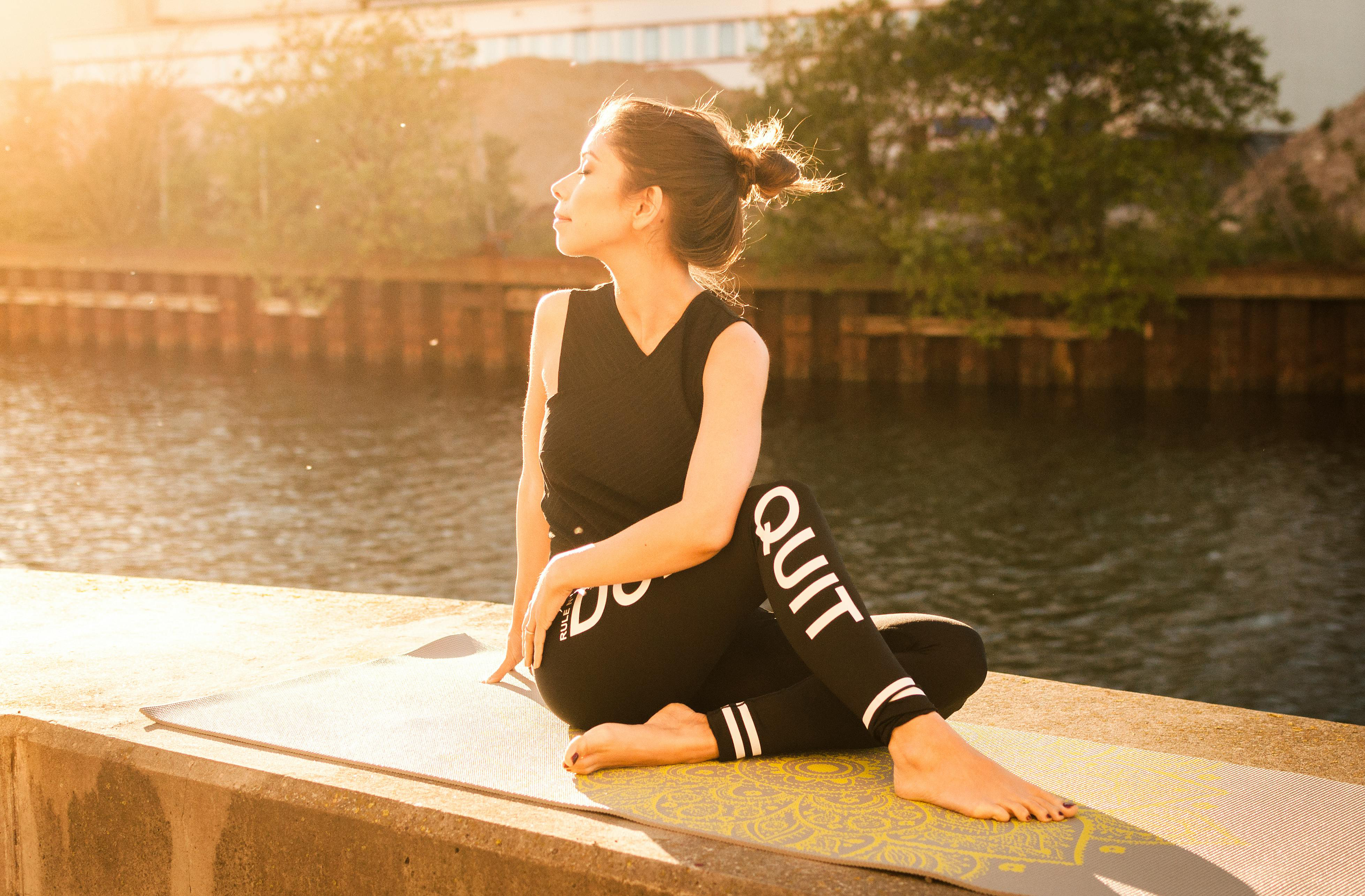 Sunset with woman doing yoga pose.