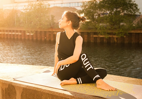 Sunset with woman doing yoga pose.