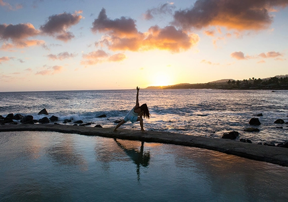 Sunset with woman doing yoga pose.
